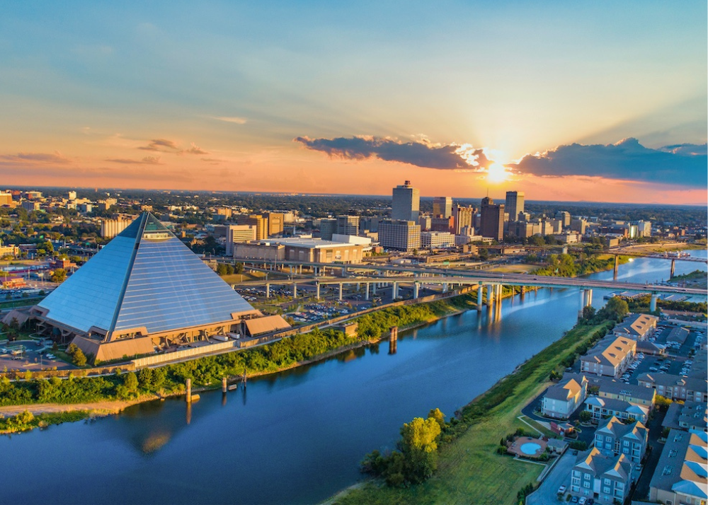 Aerial sunset view of downtown Memphis skyline with Bass Pro Shops at the Pyramid along the Mississippi River.